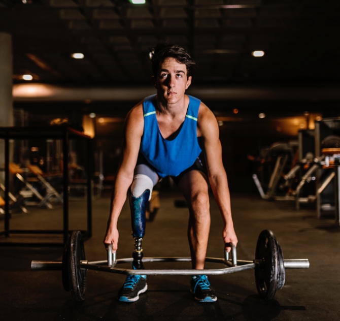 Man lifting weights at The Waterview Apartments in Richmond, Texas