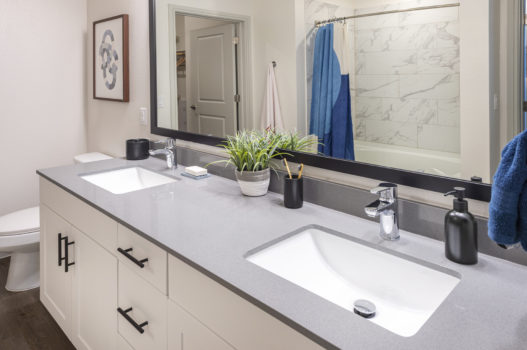 Bathroom with two sinks at The Waterview in Richmond, Texas