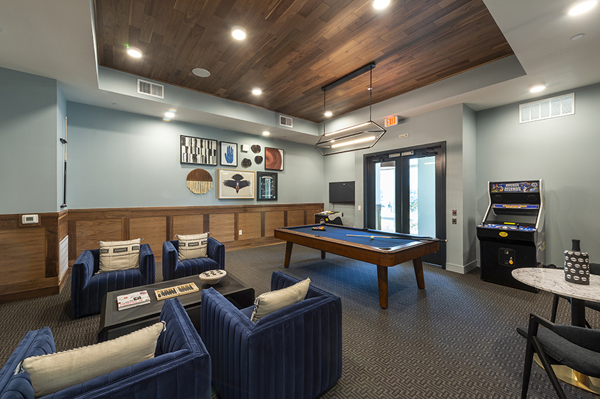 Game room with arcade game and pool table at The Waterview in Richmond, Tx